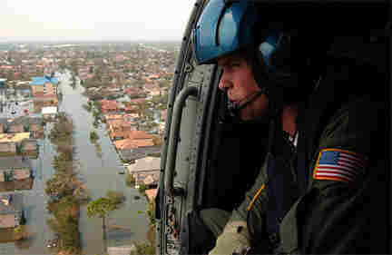 Man looking out from Helo over New Orleans flooded